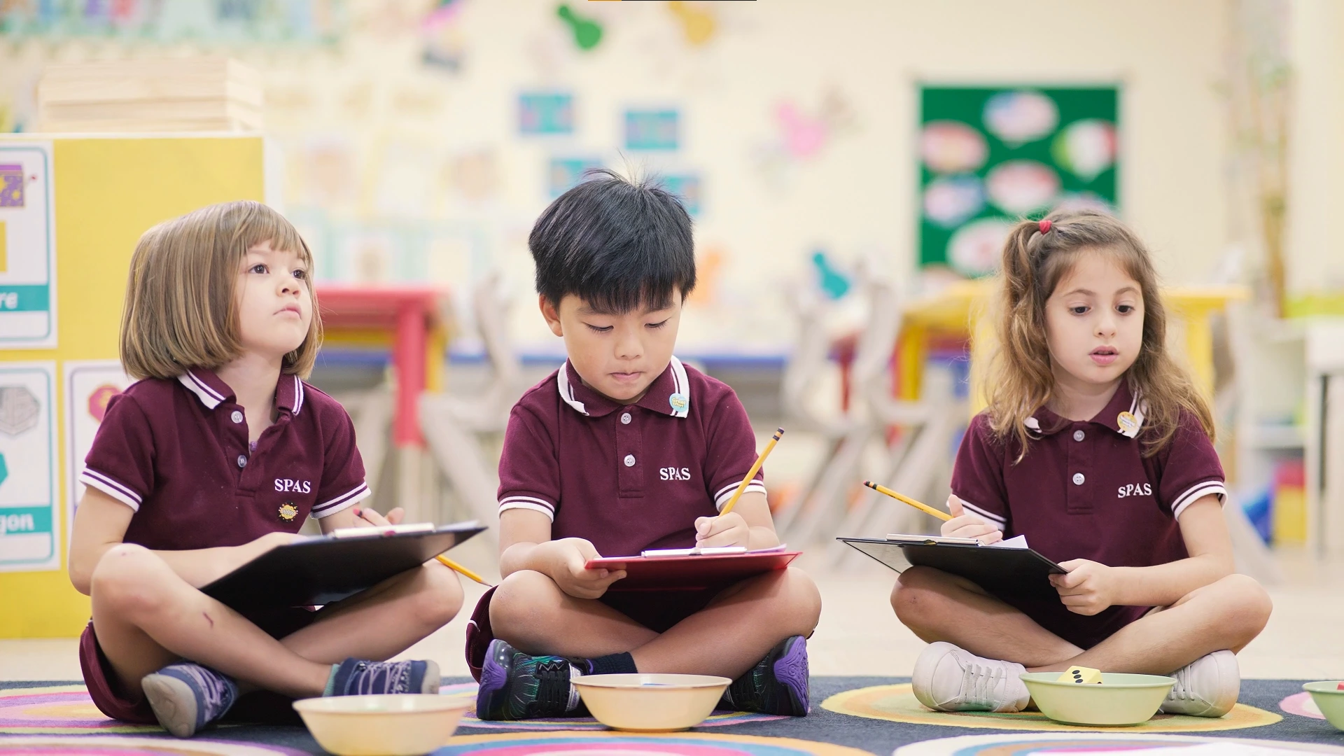 Students wearing Saint Paul school uniforms for Grades Kinder to 5, showcasing a neat and formal design